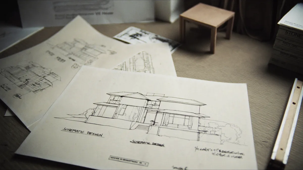 Architectural drawings and material samples on a table in a Toronto design-build studio